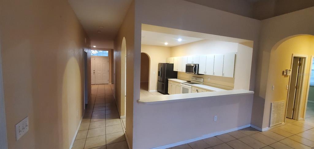 810 Terranova Road Winter Haven, FL 33884 - Photo 10 of 10 a kitchen with stainless steel appliances granite countertop a sink and a refrigerator