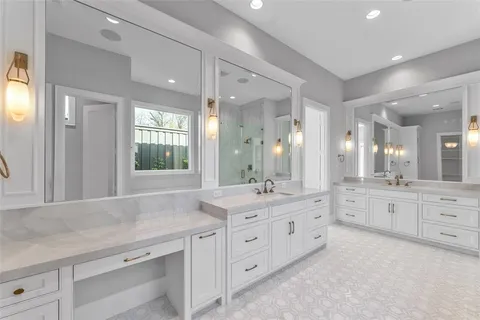 a spacious bathroom with a granite countertop sink mirror and a
