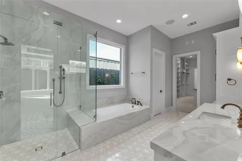 a spacious bathroom with a granite countertop tub shower and sink