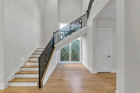 a view of entryway and hall with wooden floor