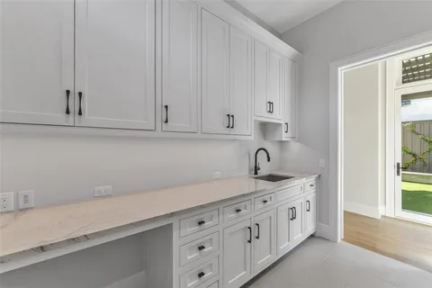 a kitchen with white cabinets