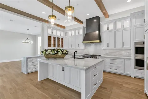 a kitchen with stainless steel appliances white cabinets and a sink