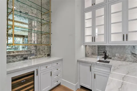 a kitchen with white cabinets and a window