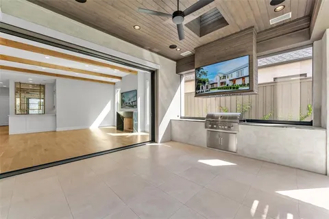 a view of a kitchen with a sink and dishwasher a stove top oven with a large window