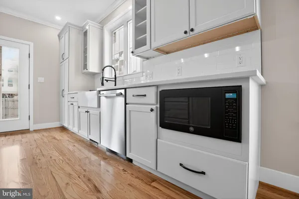 a kitchen with stainless steel appliances a refrigerator and cabinets