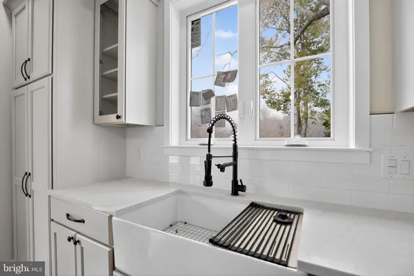 a bathroom with a bathtub and a window