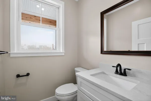 a white toilet sitting next to a bathroom sink