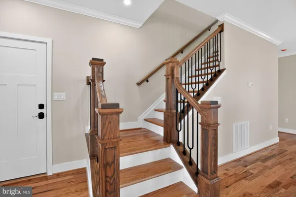 a view of entryway and hall with wooden floor
