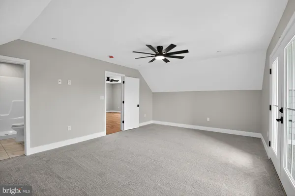 a view of an empty room with a ceiling fan