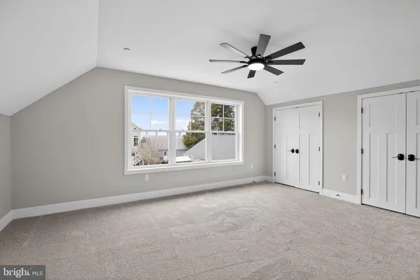 a view of a livingroom with a ceiling fan and window