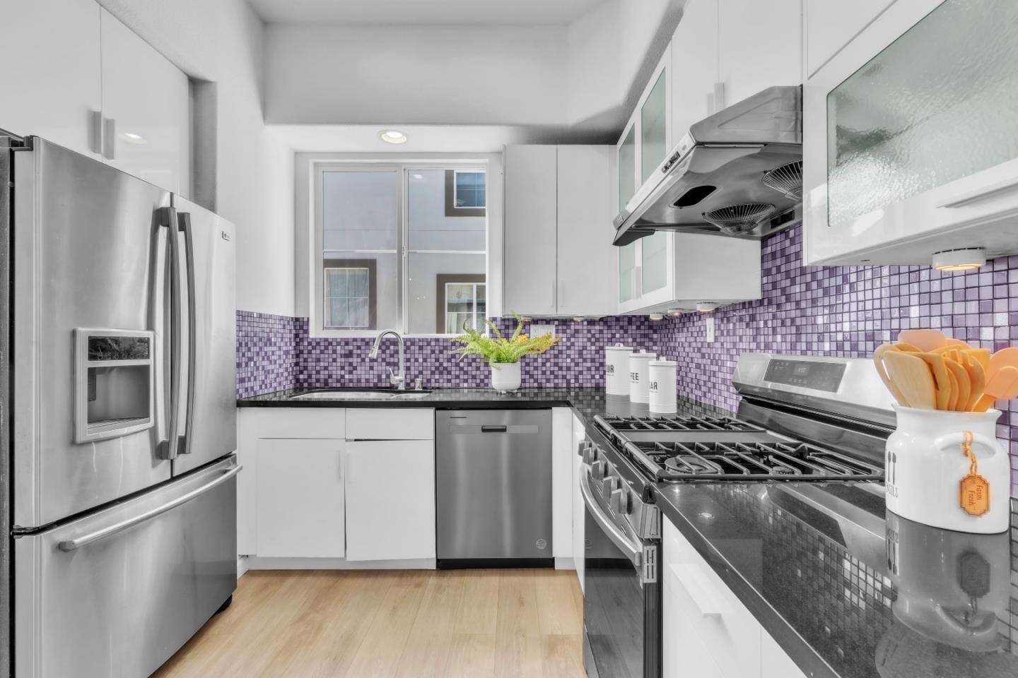 845 Fire Walk Milpitas, CA 95035 - Photo 11 of 40 a kitchen with stainless steel appliances granite countertop a stove a sink dishwasher and refrigerator
