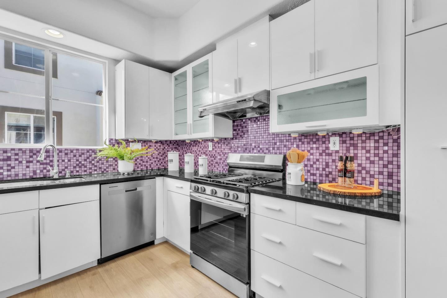 845 Fire Walk Milpitas, CA 95035 - Photo 13 of 40 a kitchen with stainless steel appliances granite countertop a stove and cabinets