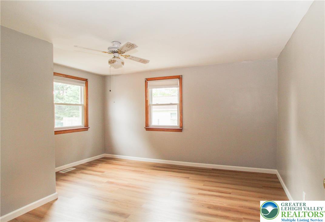 492 Filetown Road Nazareth, PA 18064 - Photo 15 of 30 Well-lit room features a ceiling fan, light wood-style flooring, and dual windows framing exterior greenery.