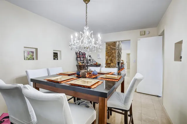 a view of a dining room with furniture and chandelier