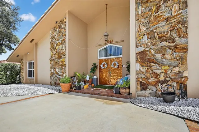 an aerial view of a houses with a swimming pool