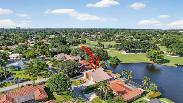 an aerial view of residential houses with outdoor space and swimming pool