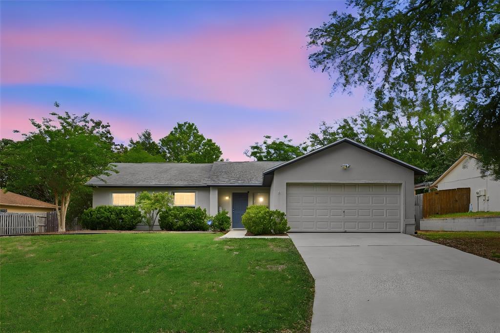 10618 Lake Ralph Drive Clermont, FL 34711 - Photo 1 of 26 a front view of a house with a yard and garage