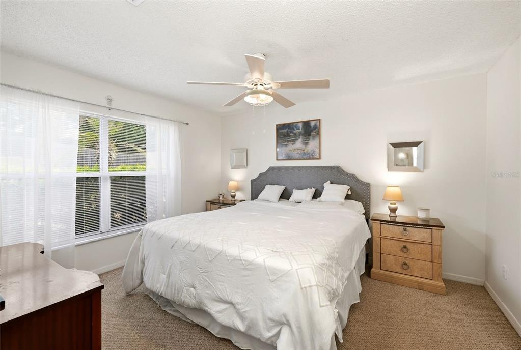 10618 Lake Ralph Drive Clermont, FL 34711 - Photo 11 of 26 a bedroom with a bed and a window