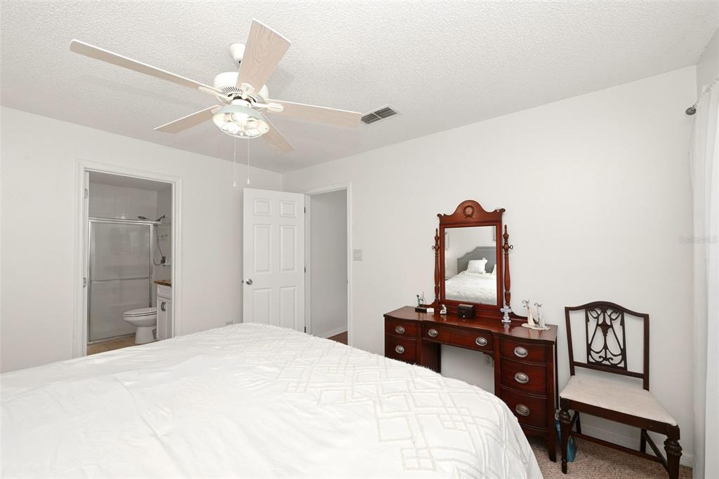 10618 Lake Ralph Drive Clermont, FL 34711 - Photo 12 of 26 a bedroom with a bed and wooden floor