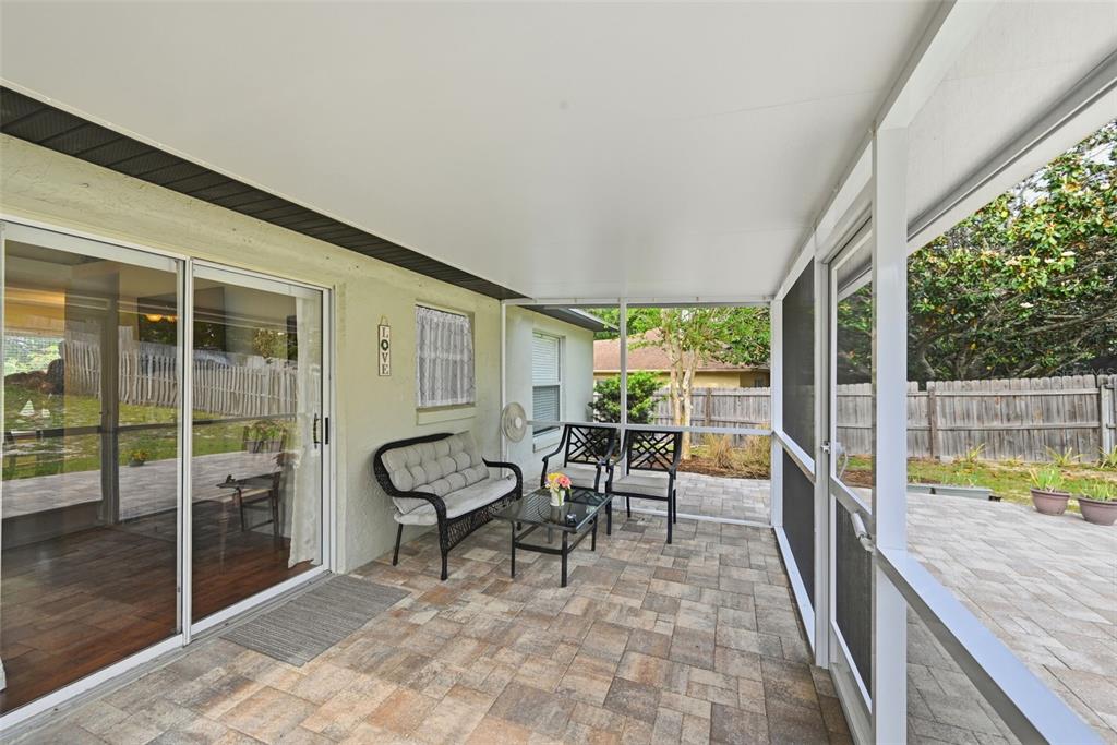 10618 Lake Ralph Drive Clermont, FL 34711 - Photo 19 of 26 a view of a porch with chairs and backyard