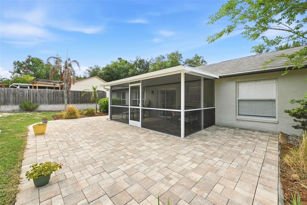 10618 Lake Ralph Drive Clermont, FL 34711 - Photo 21 of 26 a view of a backyard with a large tree and wooden fence
