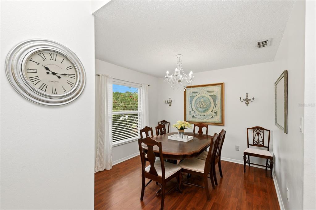 10618 Lake Ralph Drive Clermont, FL 34711 - Photo 5 of 26 a view of a dining room with furniture window and wooden floor
