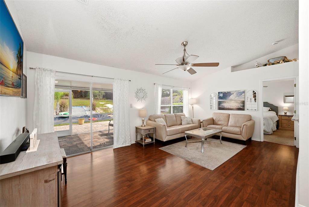 10618 Lake Ralph Drive Clermont, FL 34711 - Photo 6 of 26 a living room with furniture and wooden floor