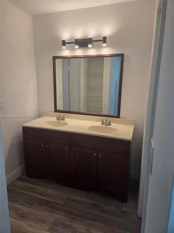 a bathroom with a sink vanity and mirror