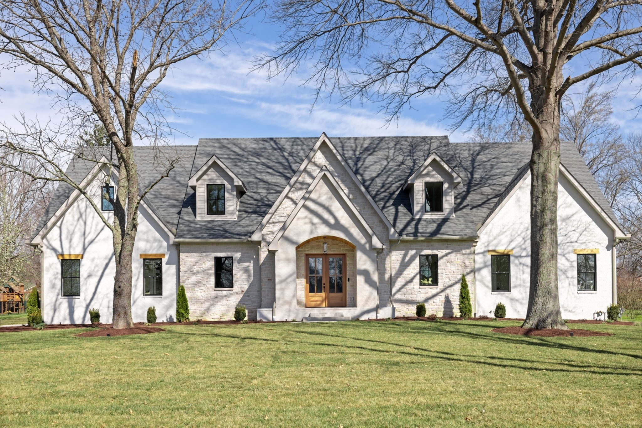 8238 Alamo Road Brentwood, TN 37027 - Photo 1 of 64 a front view of a house with a garden
