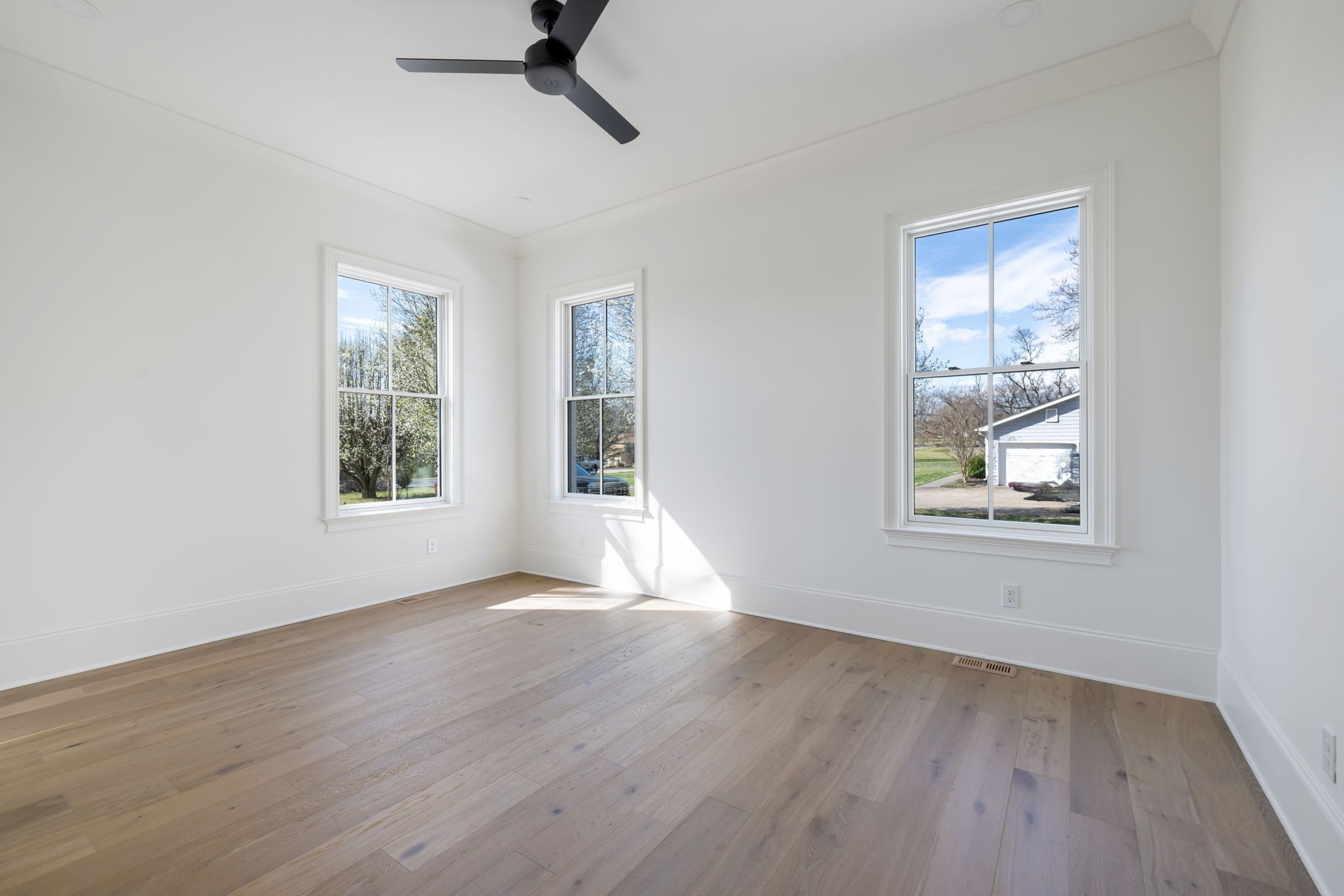 8238 Alamo Road Brentwood, TN 37027 - Photo 43 of 64 a view of an empty room with wooden floor and a window