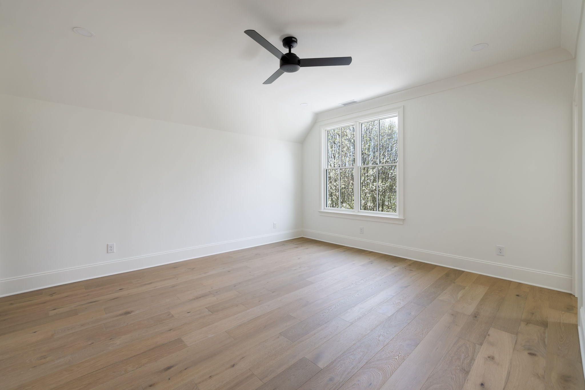 8238 Alamo Road Brentwood, TN 37027 - Photo 49 of 64 an empty room with wooden floor ceiling fan and windows