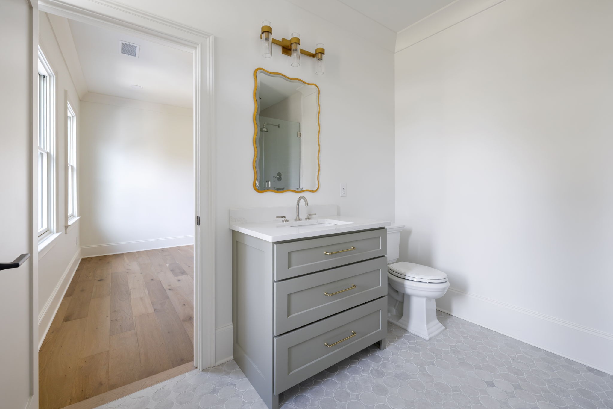 8238 Alamo Road Brentwood, TN 37027 - Photo 58 of 64 a bathroom with a toilet sink and mirror