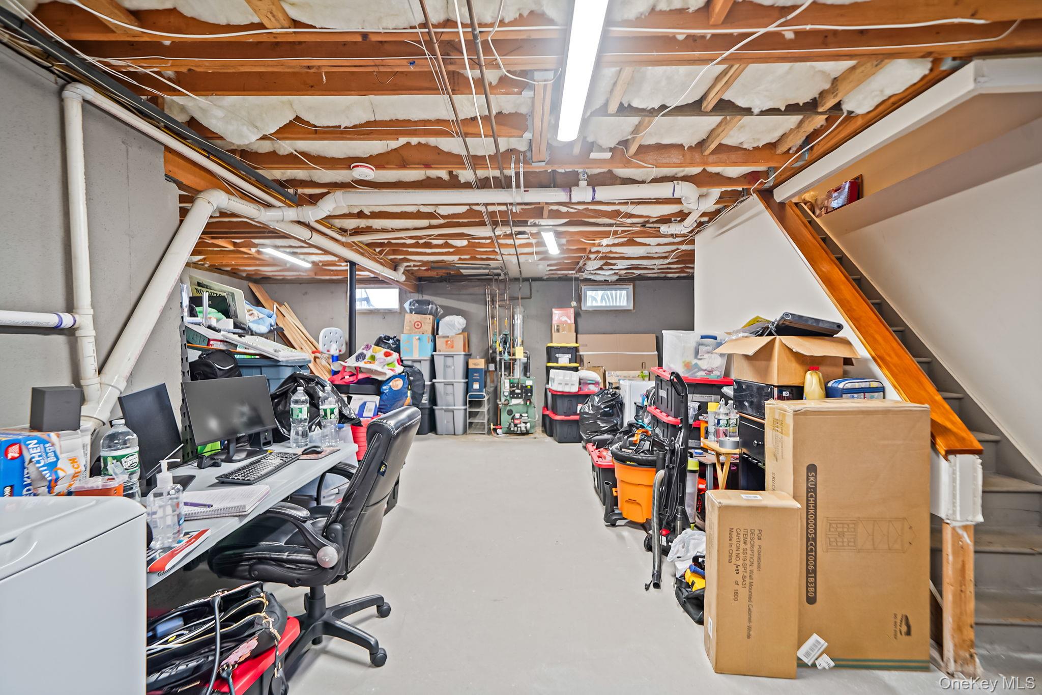 4 Willow Road Rocky Point, NY 11778 - Photo 23 of 30 Basement featuring stairway, washer / dryer, and a desk