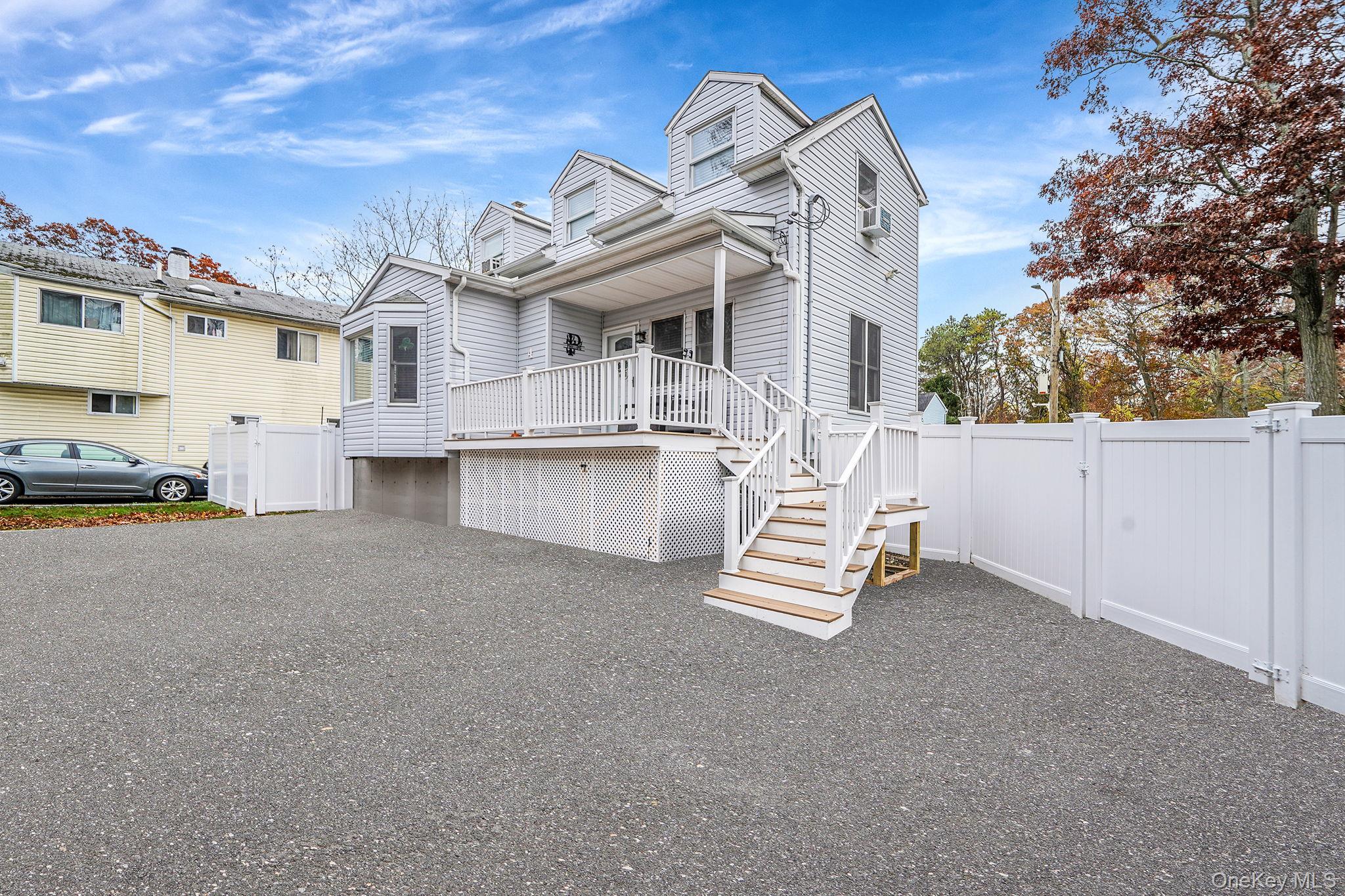 4 Willow Road Rocky Point, NY 11778 - Photo 3 of 30 View of front of home featuring a gate, stairs, driveway, and a garage