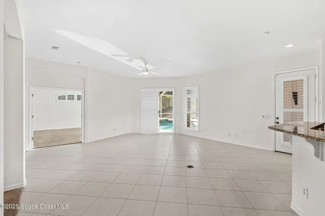 a view of a dining room with furniture and a potted plant