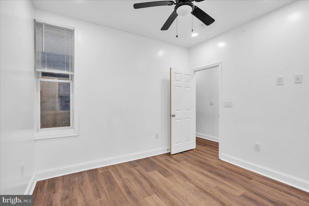 1917 West Venango Street Philadelphia, PA 19140 - Photo 16 of 24 an empty room with wooden floor cabinet and windows