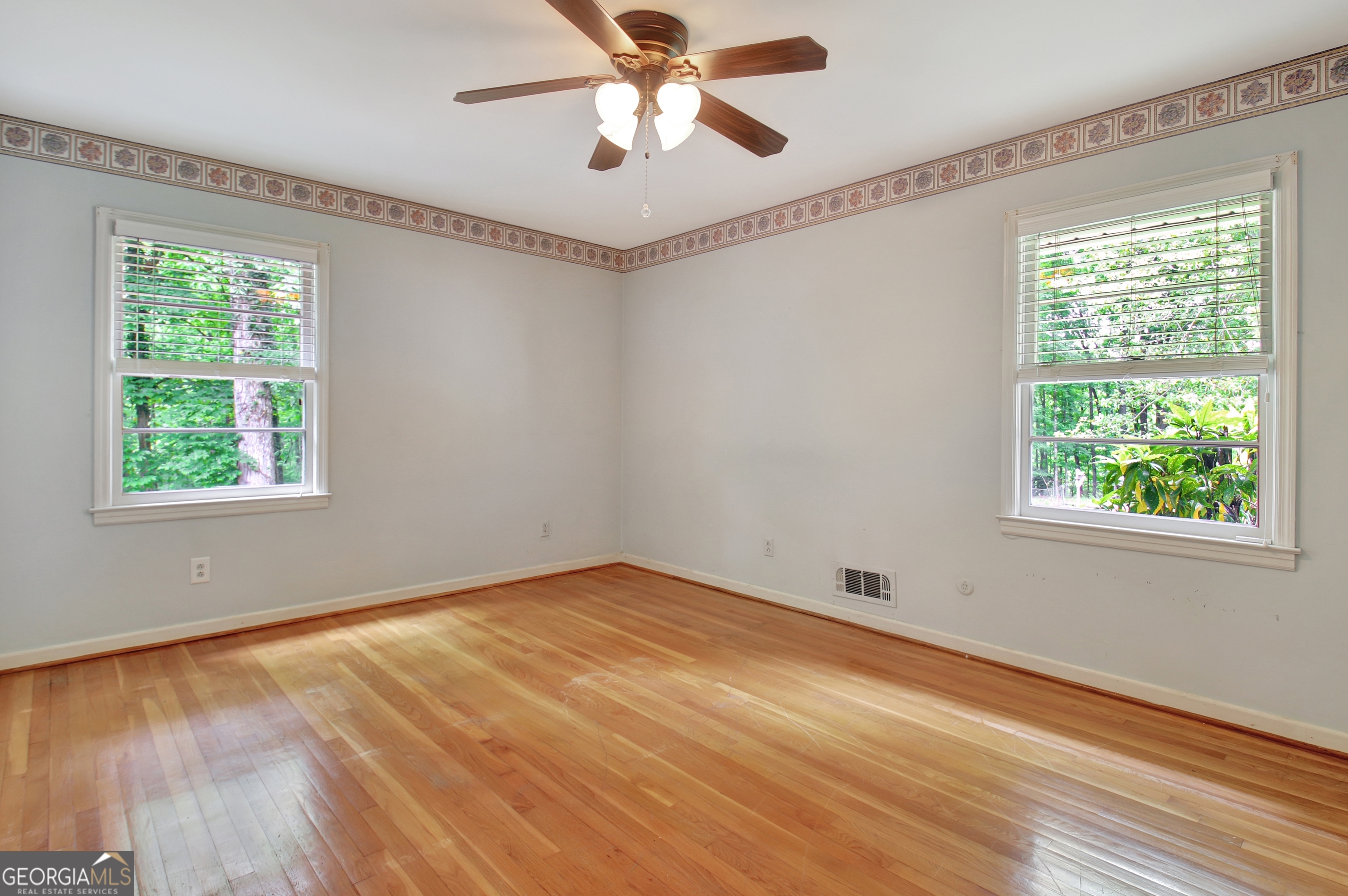 717 Tyrone Road Tyrone, GA 30290 - Photo 28 of 58 a view of an empty room with wooden floor and a window