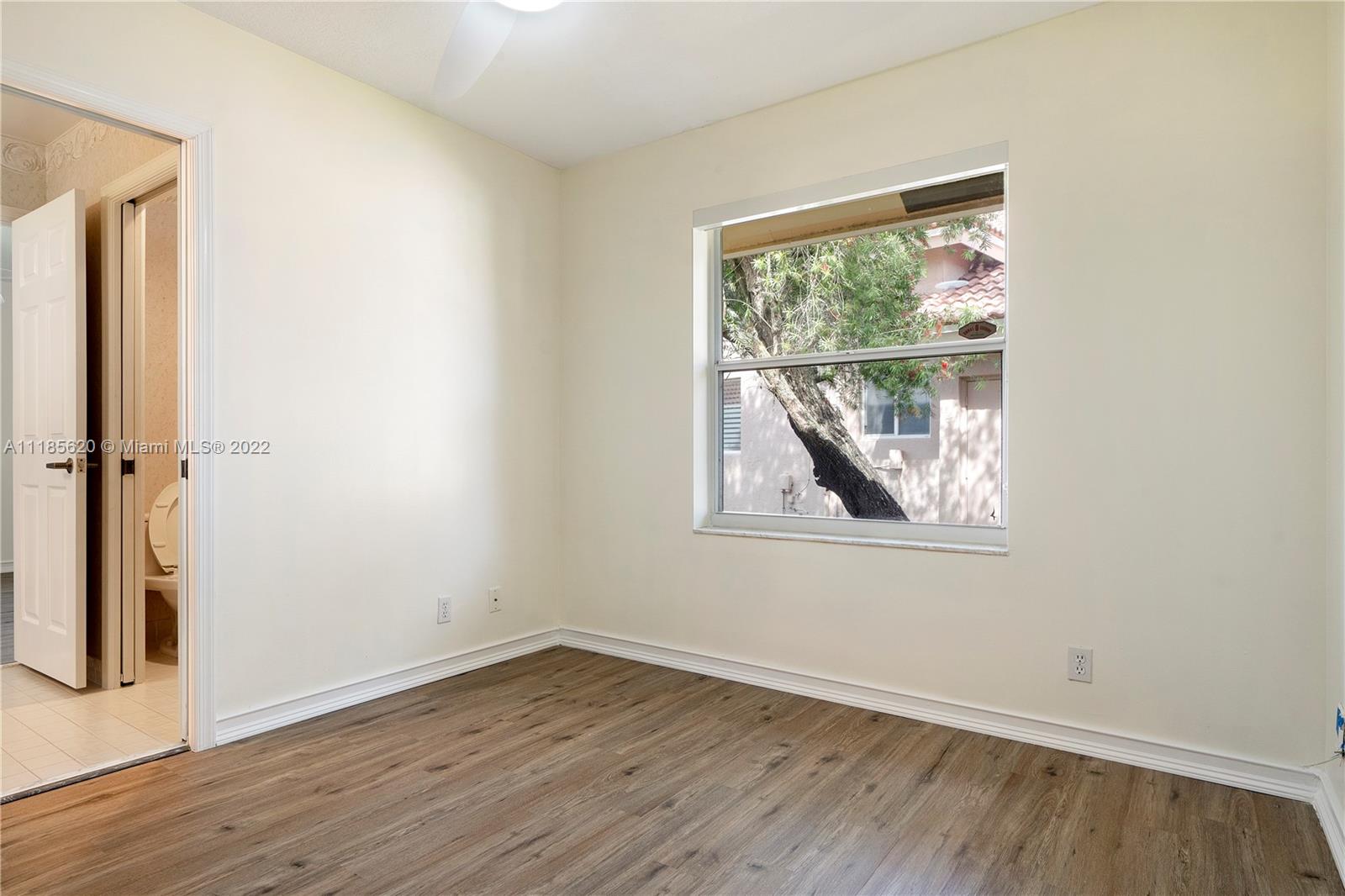 2660 Palmer Place Weston, FL 33332 - Photo 11 of 22 an empty room with wooden floor and a window