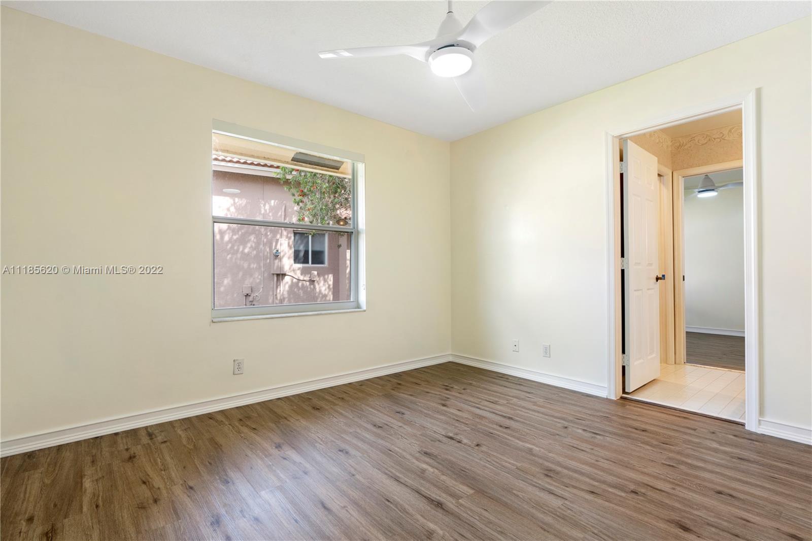 2660 Palmer Place Weston, FL 33332 - Photo 12 of 22 an empty room with wooden floor and windows