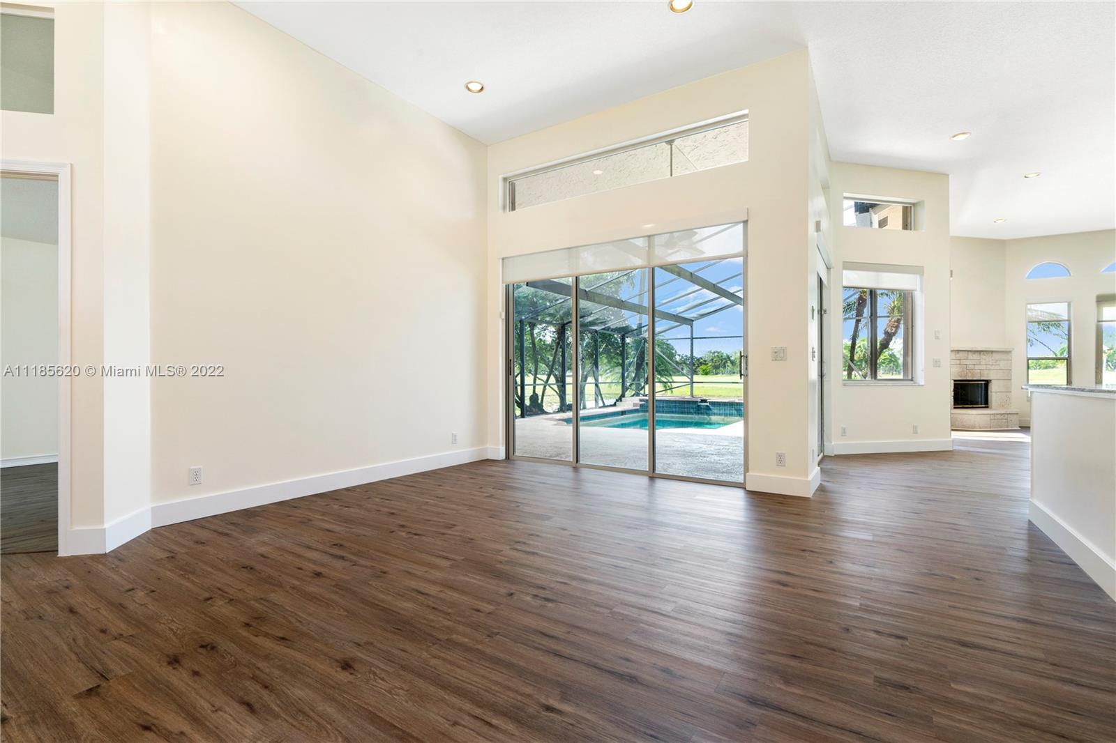 2660 Palmer Place Weston, FL 33332 - Photo 2 of 22 an empty room with wooden floor and windows