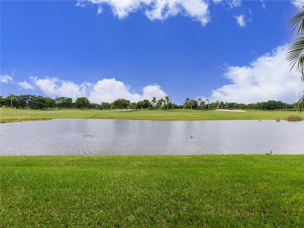 2660 Palmer Place Weston, FL 33332 - Photo 21 of 22 a view of a lake with a big yard and large trees