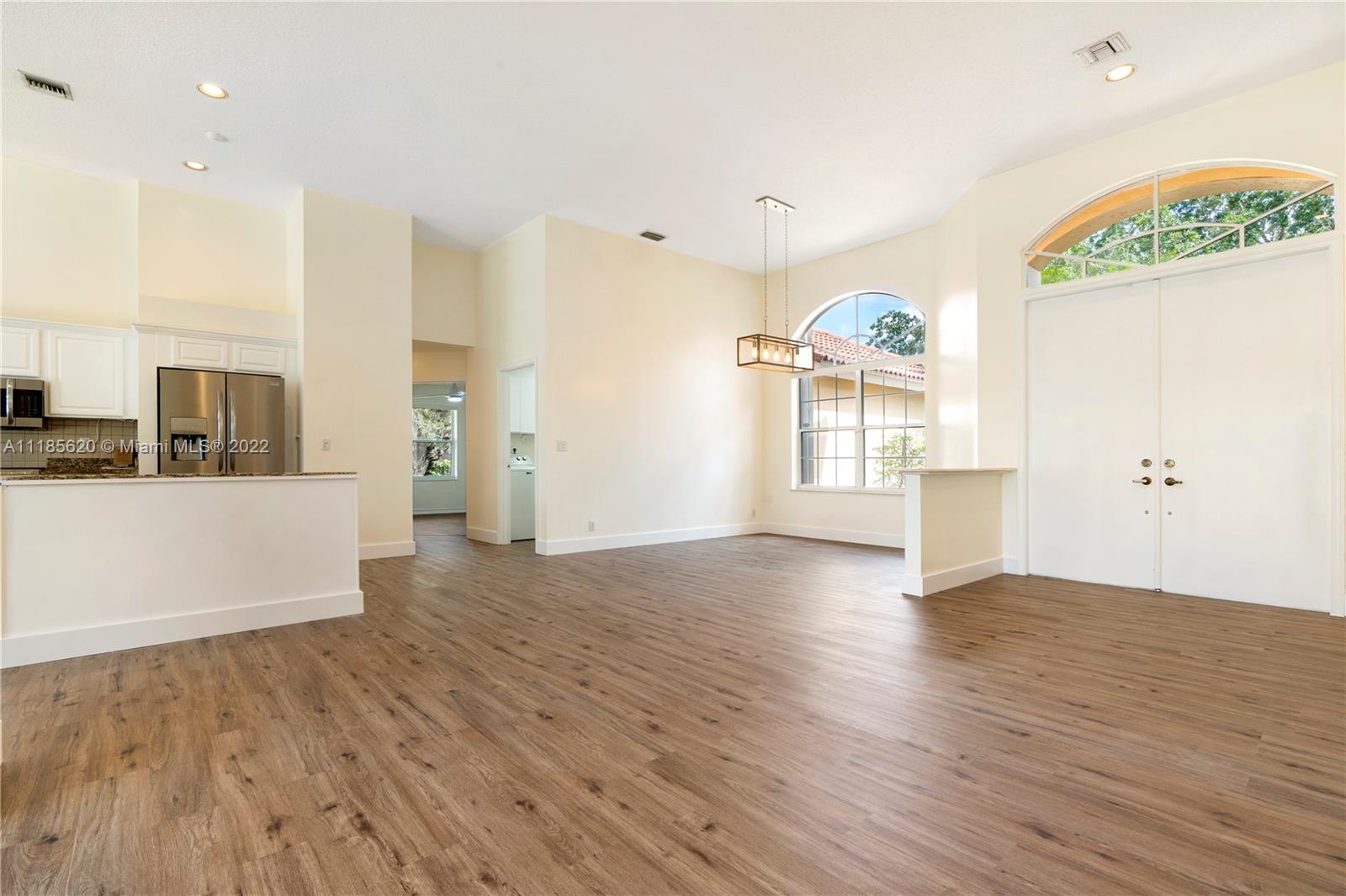 2660 Palmer Place Weston, FL 33332 - Photo 5 of 22 an empty room with wooden floor and windows