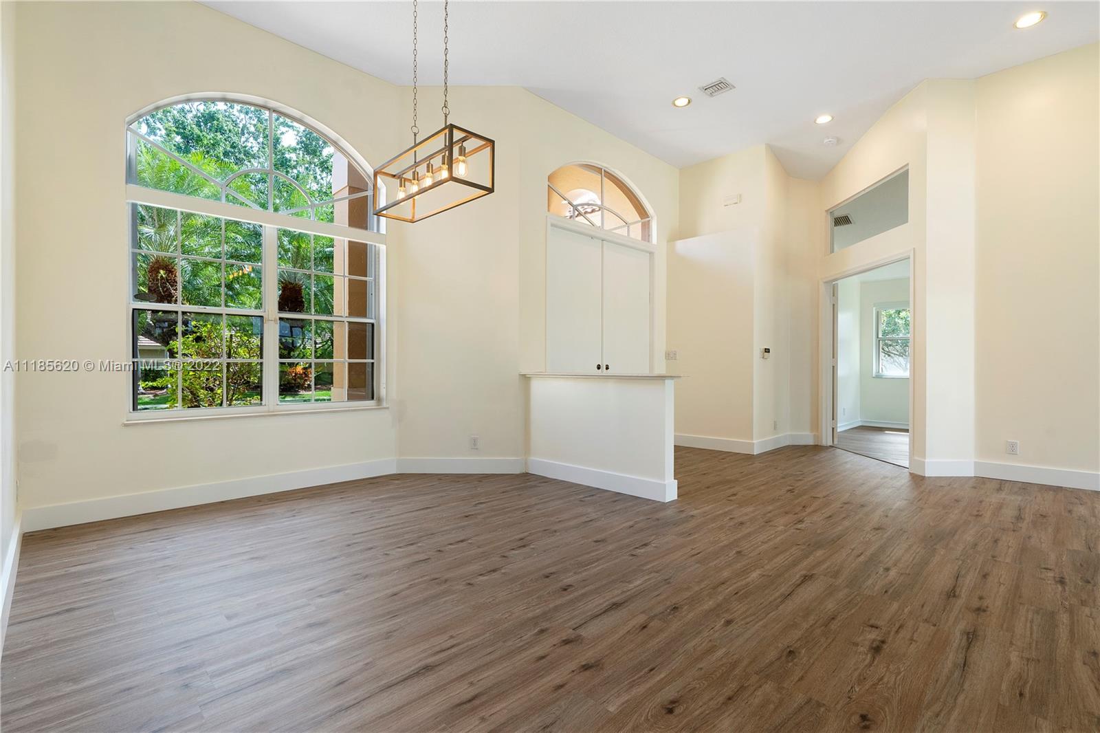 2660 Palmer Place Weston, FL 33332 - Photo 6 of 22 an empty room with wooden floor and windows
