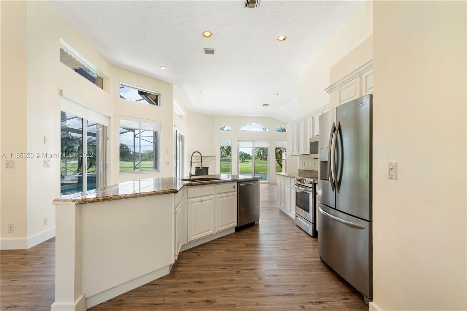 2660 Palmer Place Weston, FL 33332 - Photo 9 of 22 a kitchen with stainless steel appliances granite countertop a refrigerator and a stove top oven