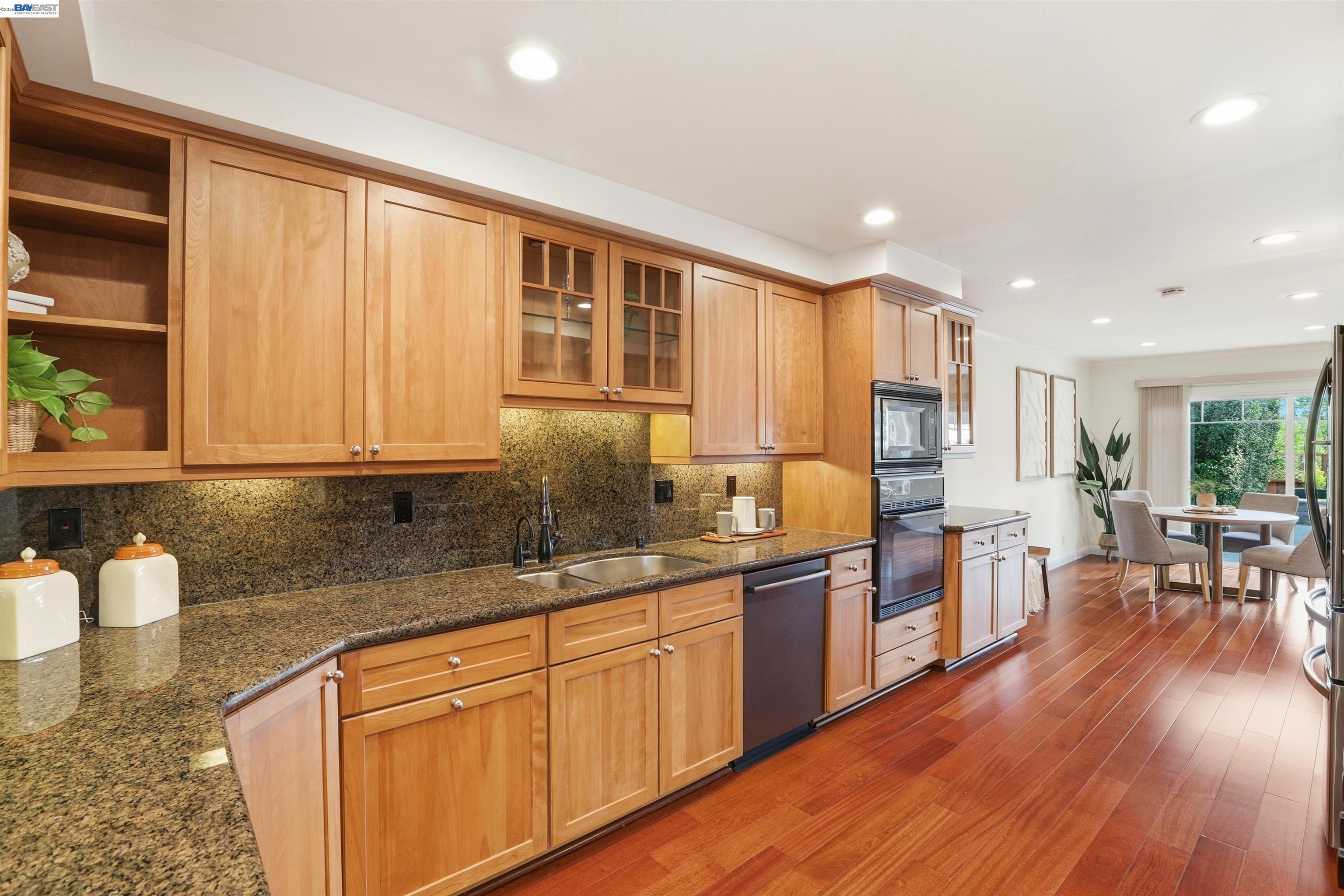 a kitchen with lots of counter top space and wooden floor