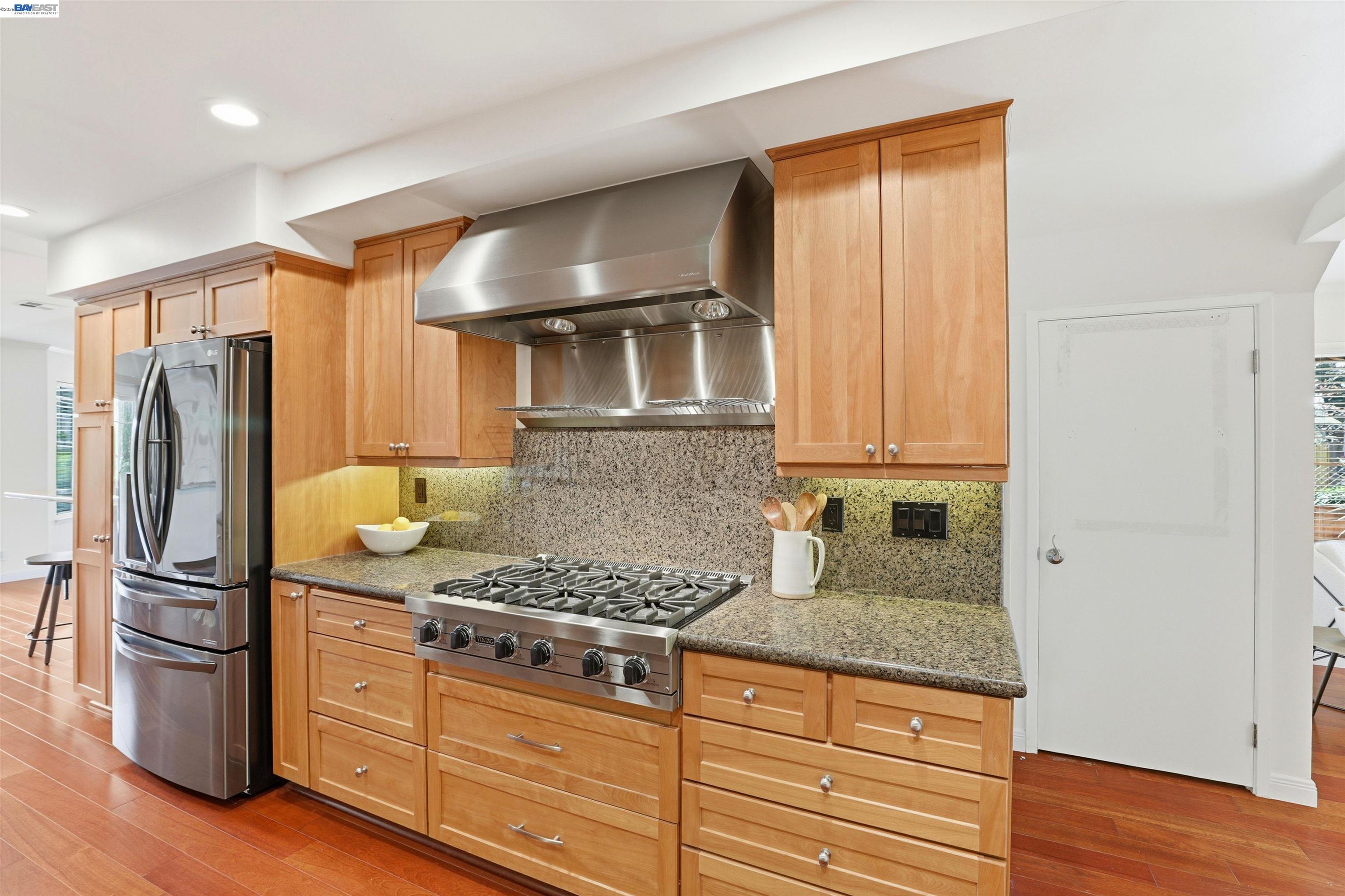 5136 Ramsgate Drive Newark, CA 94560 - Photo 2 of 59 a kitchen with granite countertop a refrigerator stove and wooden floor