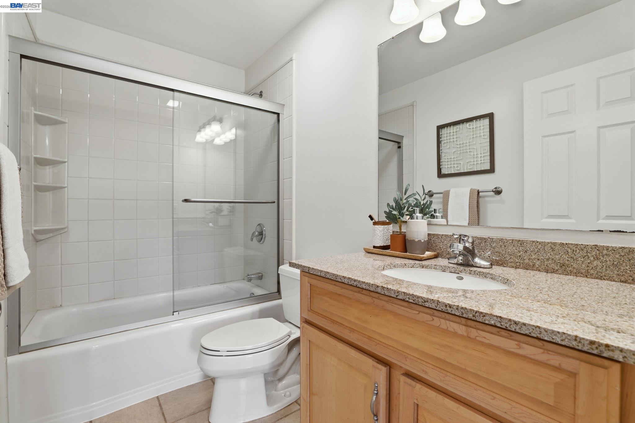 5136 Ramsgate Drive Newark, CA 94560 - Photo 23 of 59 a bathroom with a granite countertop sink toilet and shower