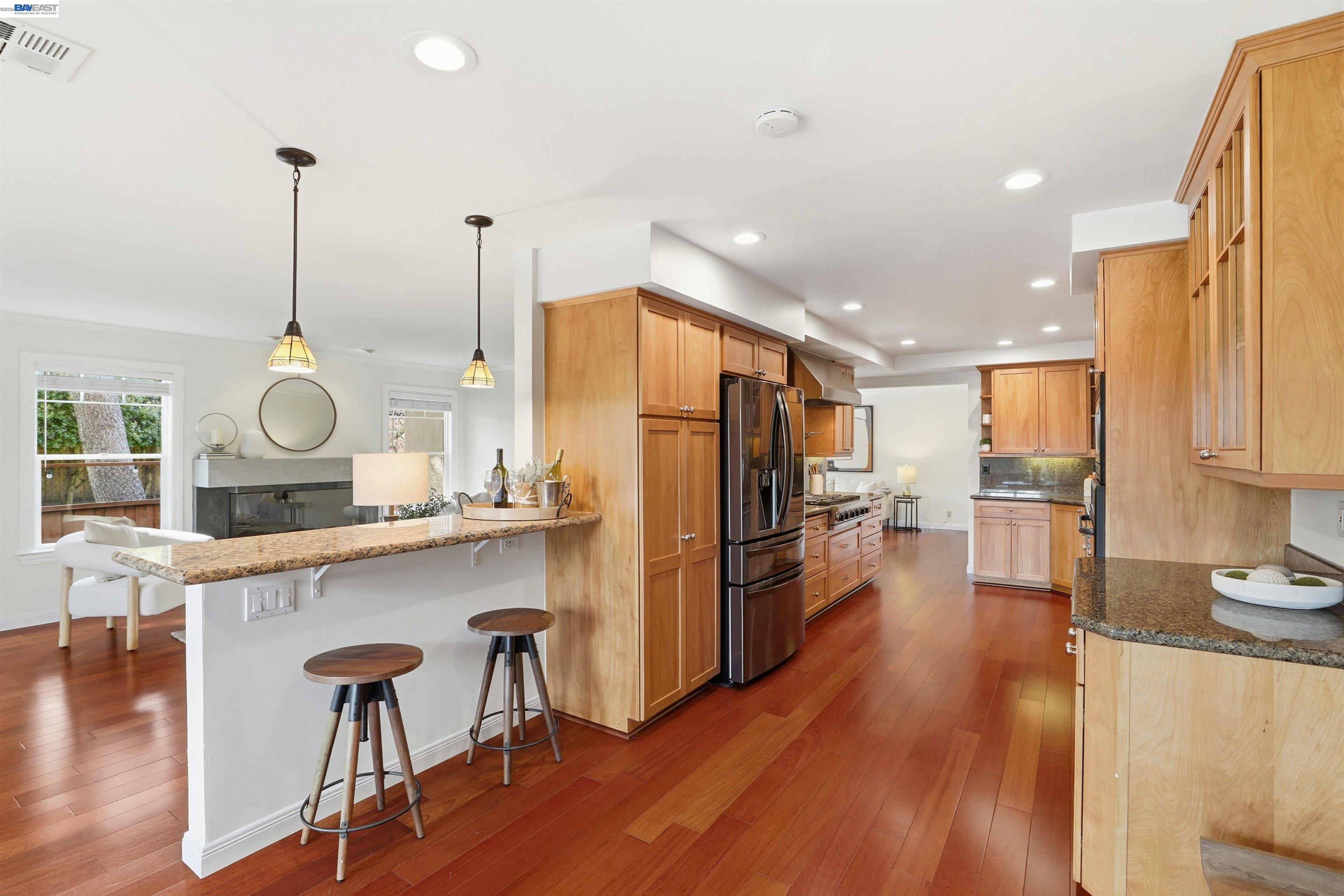 5136 Ramsgate Drive Newark, CA 94560 - Photo 28 of 59 a kitchen with refrigerator cabinets and wooden floor
