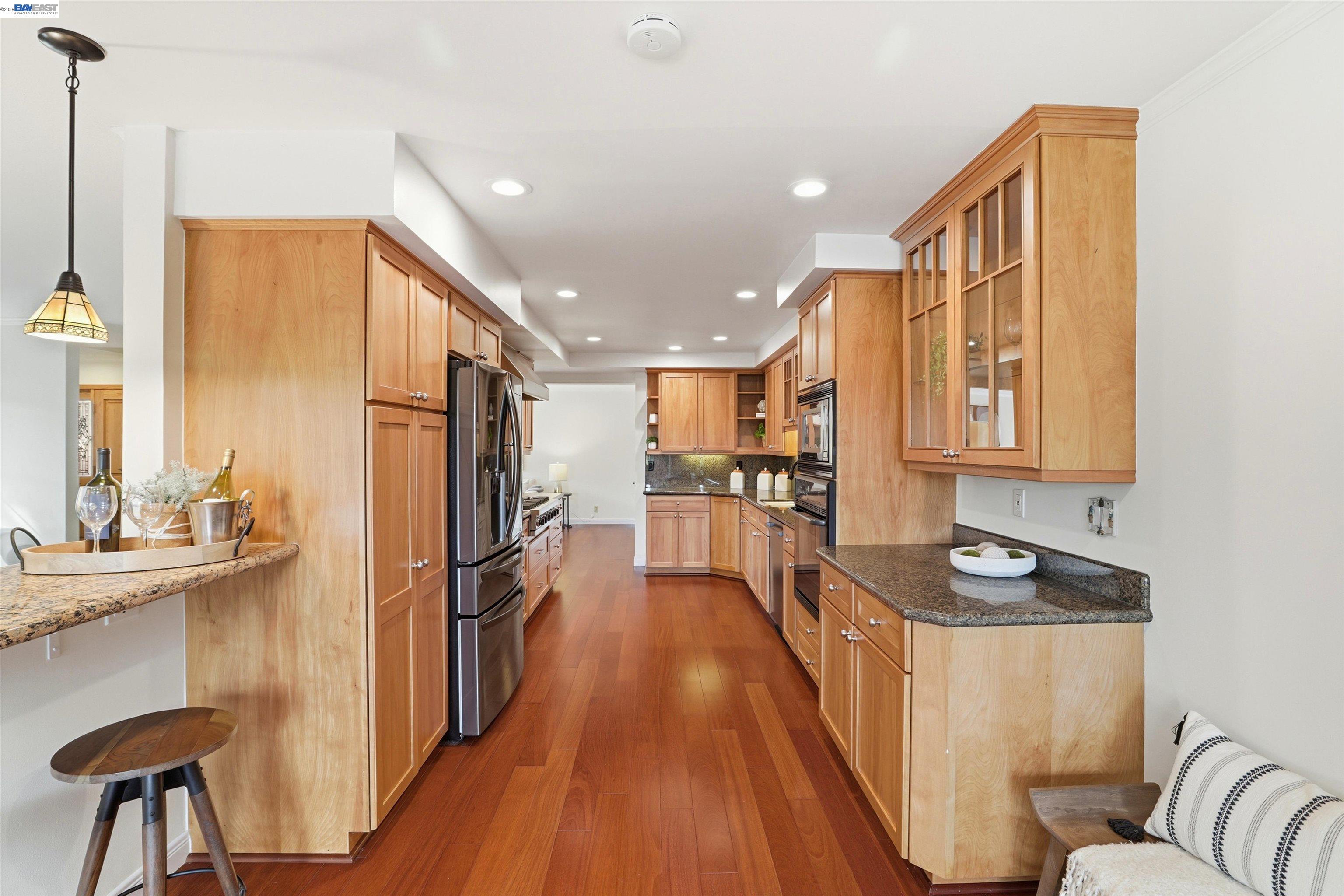 5136 Ramsgate Drive Newark, CA 94560 - Photo 29 of 59 a kitchen with refrigerator cabinets and wooden floor