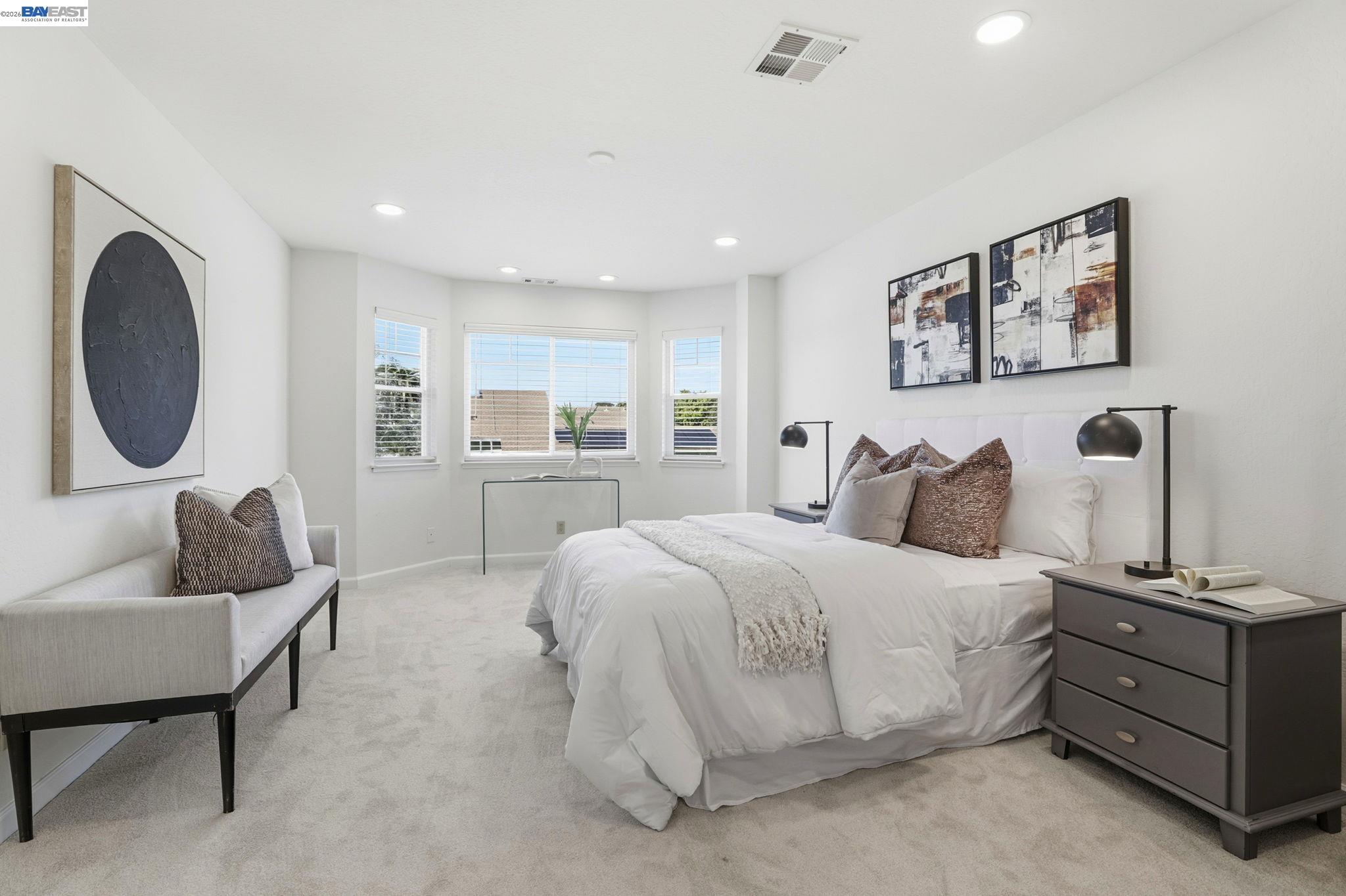 5136 Ramsgate Drive Newark, CA 94560 - Photo 34 of 59 a spacious bedroom with a bed and a couch